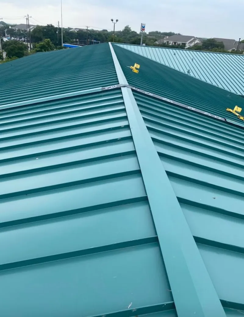 Green commercial metal roof ridge and valley for Metal Roof Repair in Ipswich