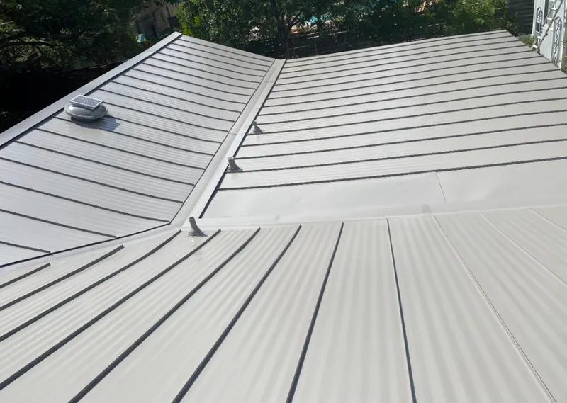 Solar attic fan installed on a metal roof for Roof Ventilation in Ipswich